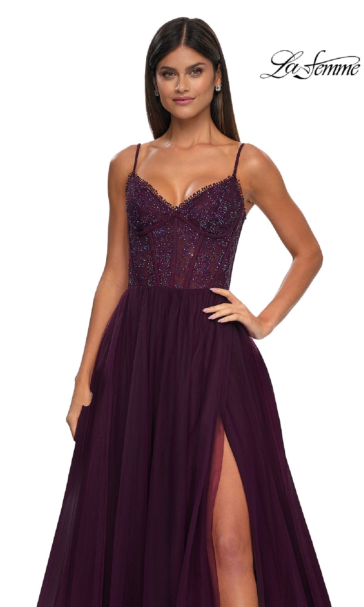 A woman wears the La Femme 32594 beaded-bodice long prom ball gown, featuring a sleeveless deep purple design with thin straps and a thigh-high slit. La Femme logo appears in the top right corner, making it perfect for prom night.